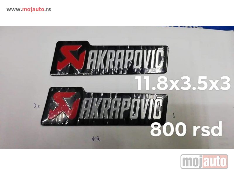 Glavna slika -  akrapovič amblem samolepljivi. dimenzija:11,8x3,5x3cm. cena:800 rsd/komad. - MojAuto